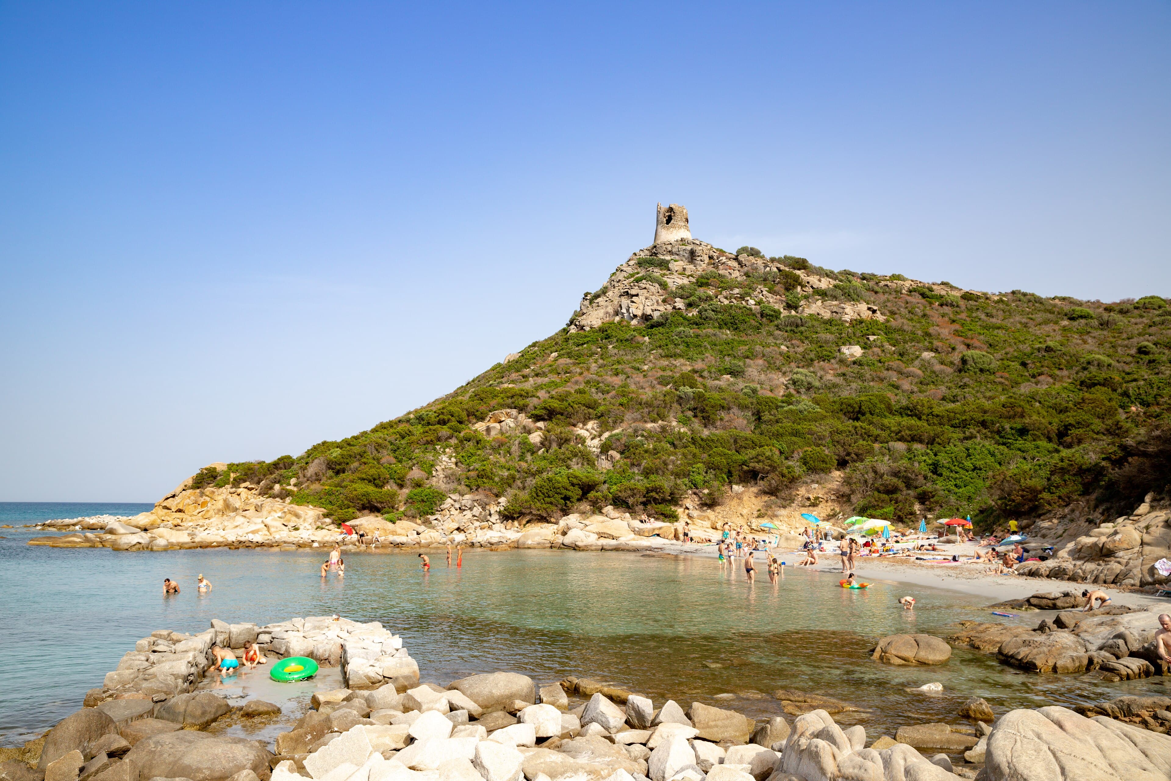 Pale water and the coastal tower at Porto Giunco, Villasimius, under strong southern light.