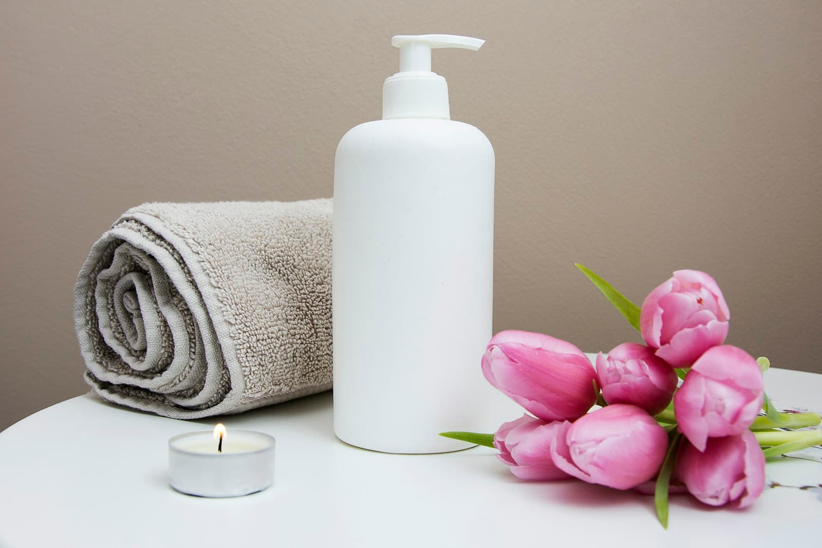 A calm treatment room prepared with linen and soft light.